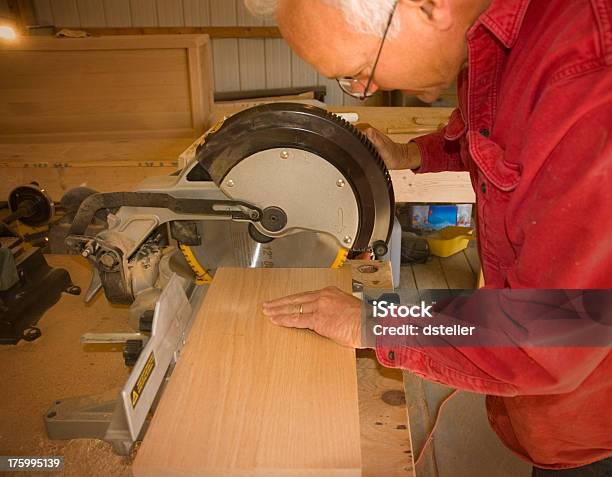 Carpenter Cutting A Board Stock Photo - Download Image Now - AARP, Accuracy, Adulation