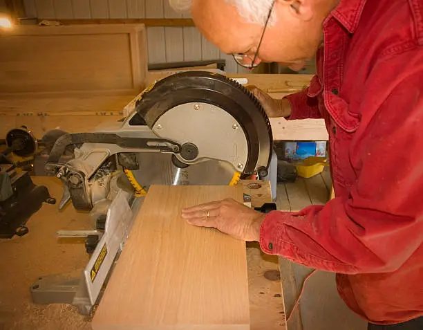 Photo of Carpenter Cutting a board