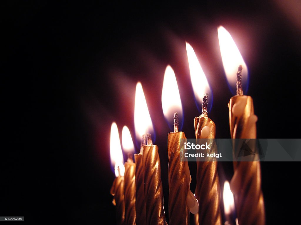 Burning Candles "A row of gold lit candles, with focus on second from front.  See also" Today - Single Word Stock Photo