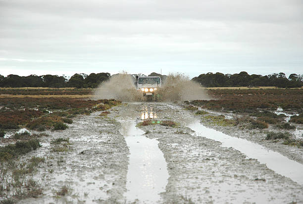 Car splashing through mud stock photo
