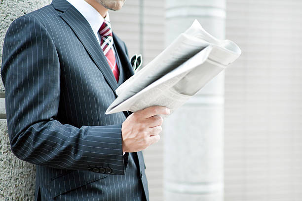 istock A man in a suit reading a newspaper 175995873