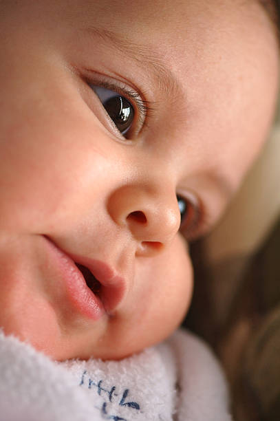 gentle smile A baby smiles with her starry eyes. stars in your eyes stock pictures, royalty-free photos & images