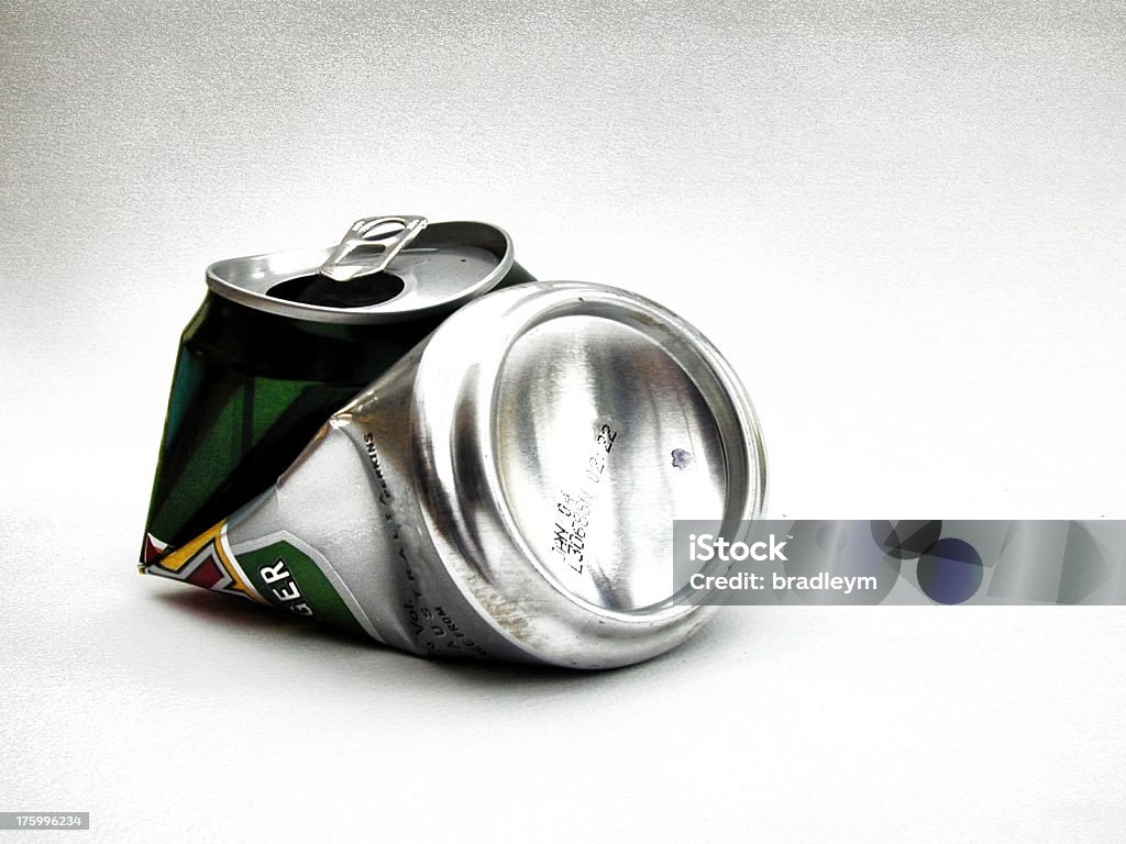 Close-up of crushed aluminum drink can on white background A lager can... crushed against a white background. Beer - Alcohol Stock Photo
