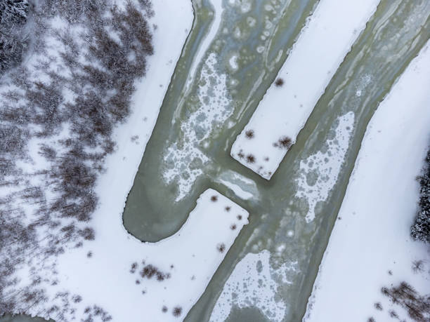 aerial view of winter frozen ponds covered with snow and ice stock photo