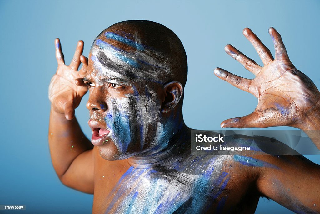 Tribal on Blue Black man with make up and hands up Adult Stock Photo