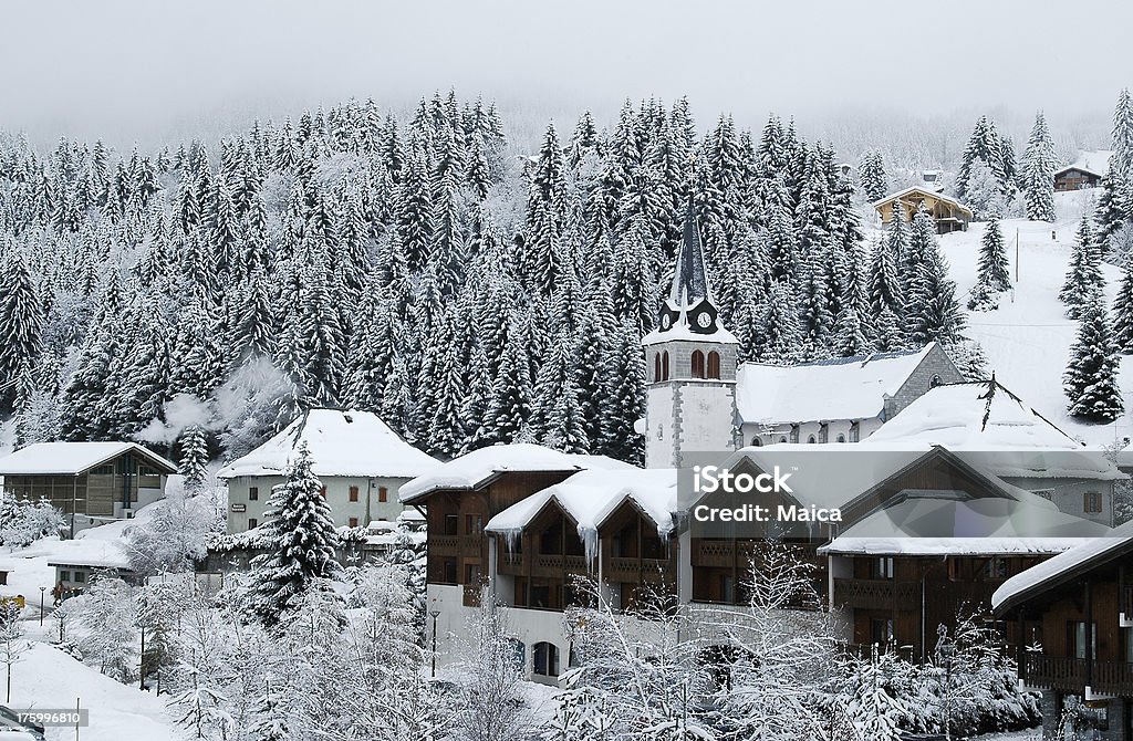 Alpine village Snow covered village in the Alps mountains.Snow holidays Lightbox Snow Stock Photo