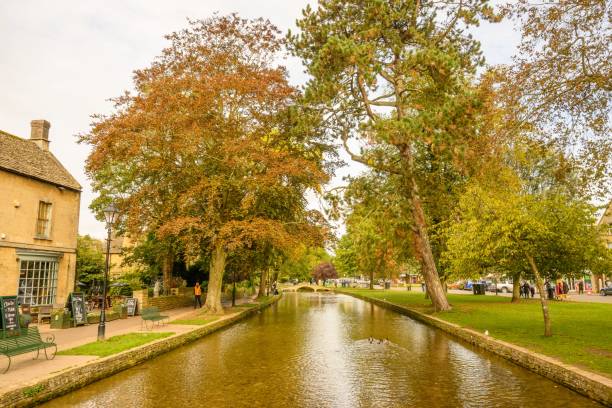 istock a river runs through a village where houses stand alongside a tree lined street 1759971941