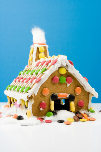 Decorated christmas gingerbread house in homely cozy atmosphere. Preparing to celebrate Christmas.