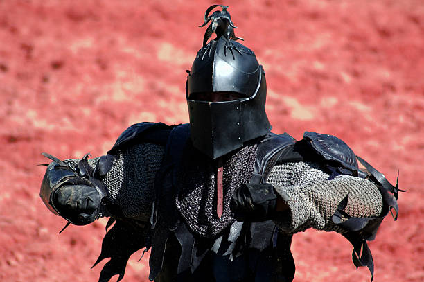 Dark Power A black knight in front of a burning environment. black knight stock pictures, royalty-free photos & images