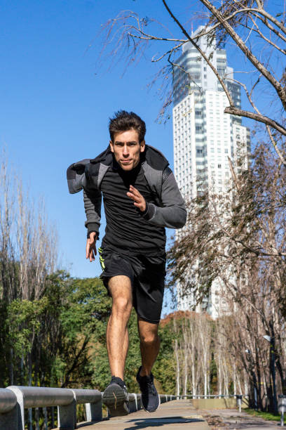istock Runner athlete silhouette running fast in public park. 1759982087