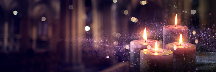 4 Purple Candlelights Burning In The Darkness With Glittering On Flames And Bokeh