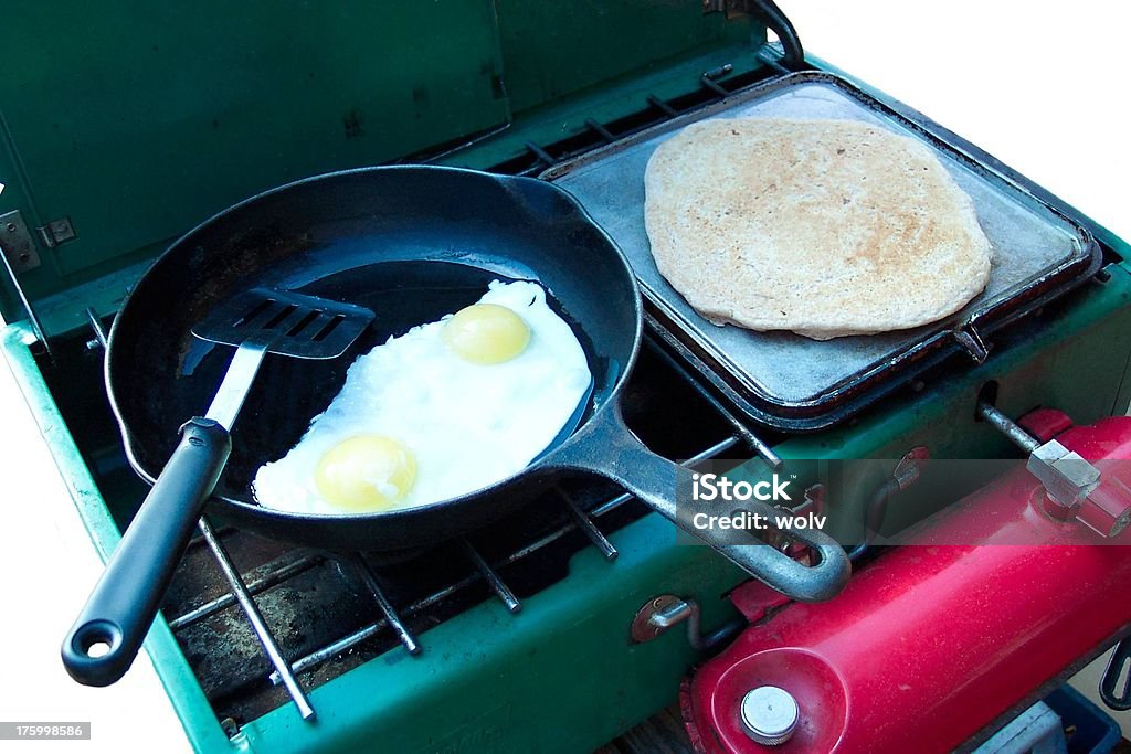 Breakfast Pancakes and eggs on a coleman stove. Camping Stove Stock Photo