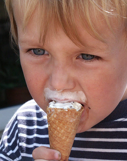 istock Close-up of boy eating ice cream from cone 175999446