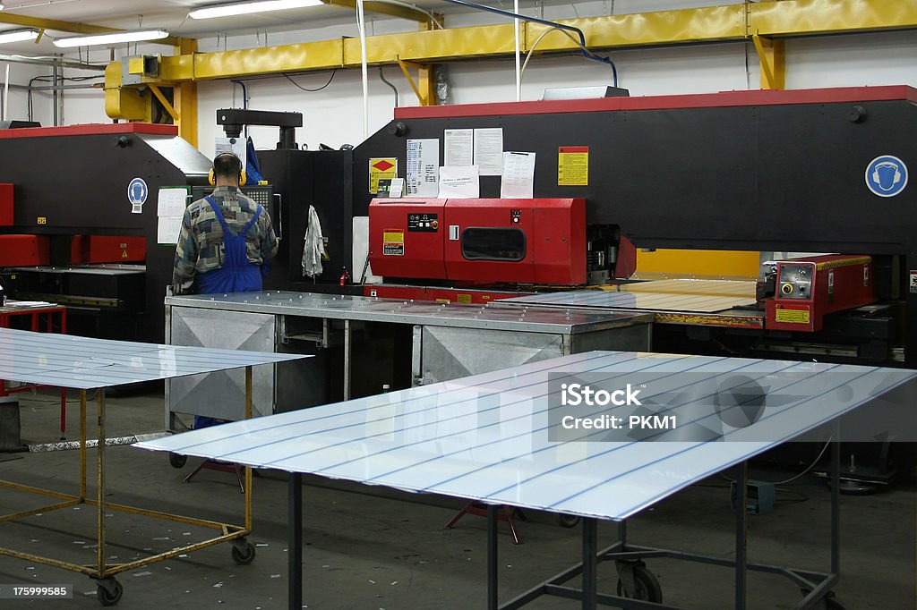 Factory Floor 2 Steel punching machines with operator changing program Machinery Stock Photo