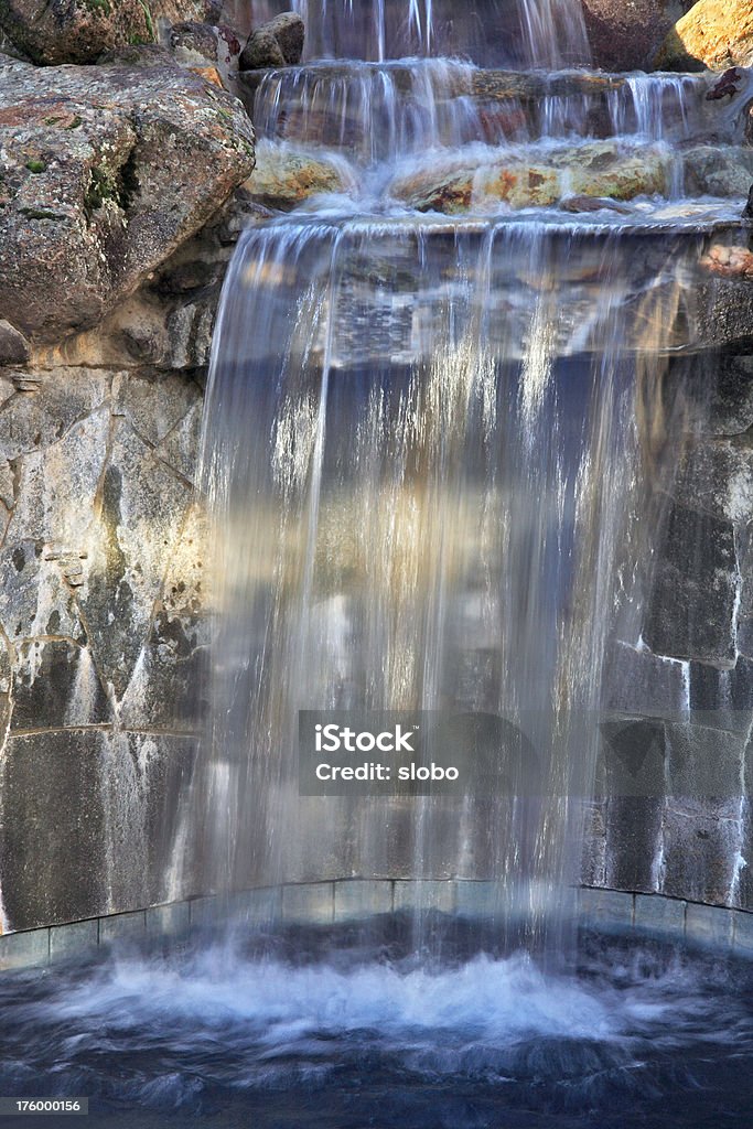 Waterfall into the swimming pool final "January 5, sunny outside but pool in a shadow. That did not prevent me from taking a shot. Yeah." Backgrounds Stock Photo