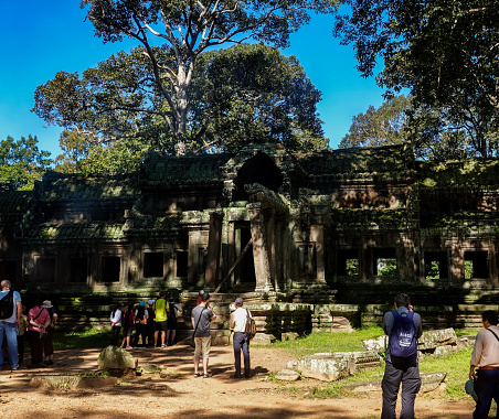 Siem Reap, Cambodia - 9th January 2019 : Majestic view of the Angkor Wat temple building with tourist walking in front of it.