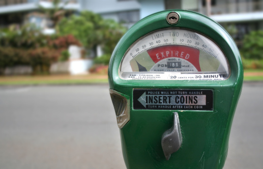 A green parking meter with red time expired notice.