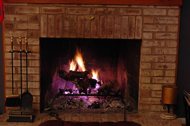 Purple Fireplace A roaring fire with interesting color. mickey mantle stock pictures, royalty-free photos & images