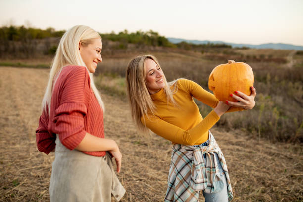 istock Two sisters with a pumpkin for Halloween 1760008835
