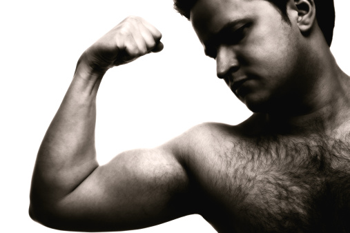 Black and white image of a man flexing his arm.