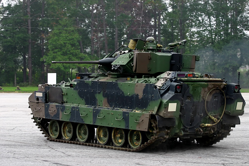Rear view of a US Army M2 Bradley tank. Vehicle is in motion, hence the slightly blurred tracks.