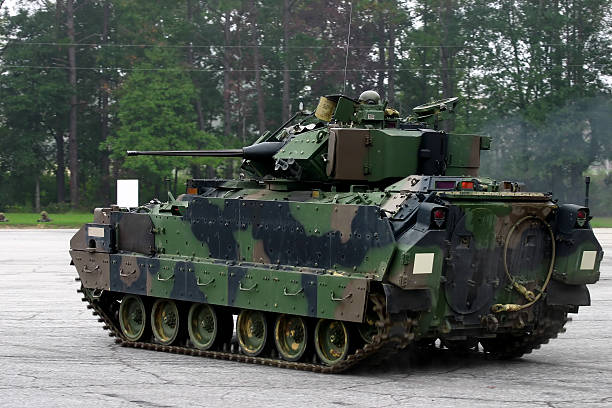 M2 Bradley Armored Fighting Vehicle on concrete yard Rear view of a US Army M2 Bradley tank. Vehicle is in motion, hence the slightly blurred tracks. military deployment photos stock pictures, royalty-free photos & images