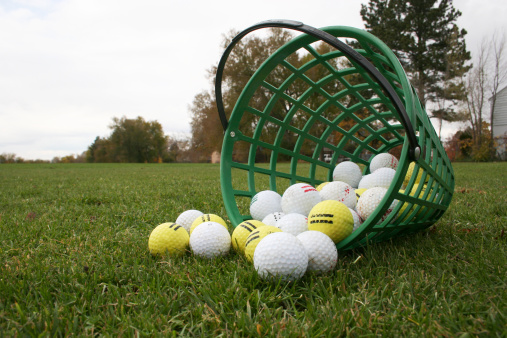 A bucket of golf balls at the driving range on a cold November day--ready for that 7-iron.