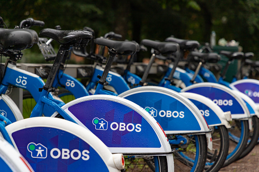 Oslo, Norway - August 12, 2023: A picture of the Oslo city bikes, or Bysykkel, with the Obos brand.