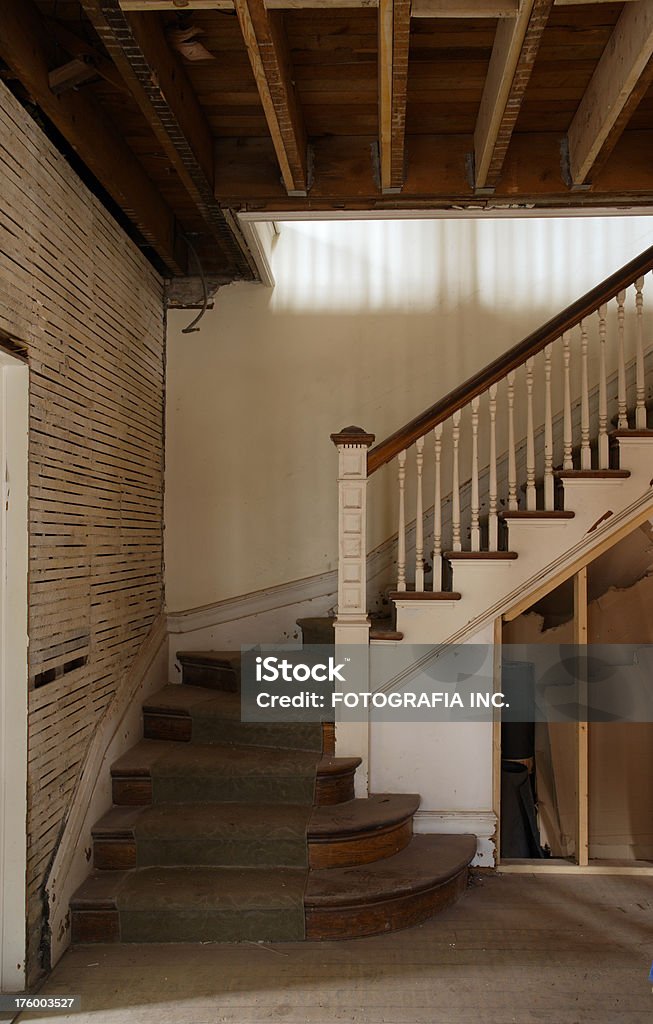 old stairs "Old stairs in the house ready for major reconstuction/remodeling. Walls are already stripped of old plaster, some wall panels are missing, walls are old and damaged. This is a perfect ""before and after"" image for house renovation." Before and After Stock Photo