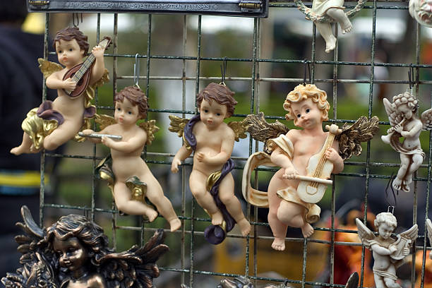 angels "angel figures in a flea maket in coyocan neighborhood, mexico city." winged cherub stock pictures, royalty-free photos & images