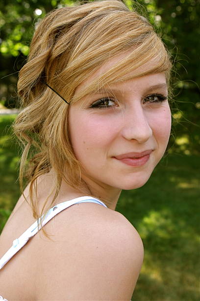 beautiful young woman sitting on a tiled floor.
