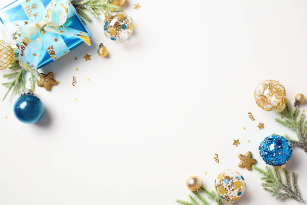 istock Christmas card template. Flat lay composition with gift box, fir tree branches, blue and gold decorations in corners of Christmas background. 1760046253