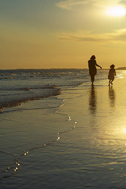 istock Mother and child walking on beach 176004952