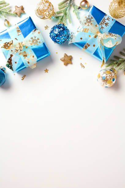 istock Vertical Christmas background with blue and gold decorations, gift boxes on white background. Top view. Flat lay. 1760050036