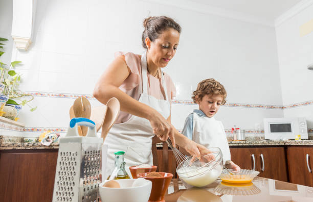 istock A woman and a child beating eggs. 1760050633