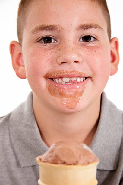 istock Young boy enjoying a chocolate ice cream cone 176005211