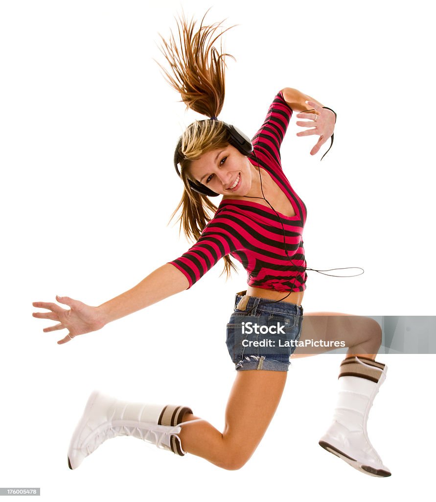 Giovane ballerina in posa in mid-air con cuffie - Foto stock royalty-free di A mezz'aria