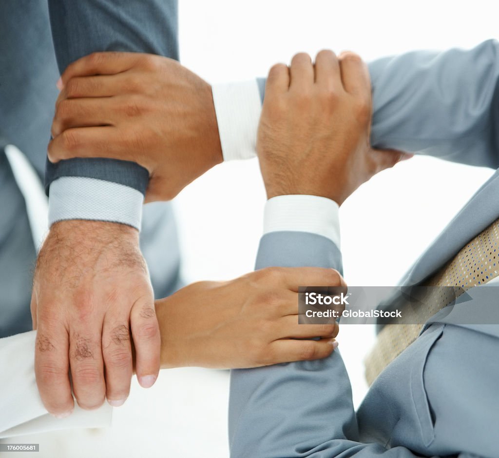 Business people holding hands Closeup of business people holding hands in unity Holding Hands Stock Photo