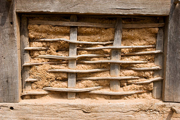 Half-timbered wall wattle and daub close-up Close-up of wattle and daub in a half-timbered wall. The mud-and-straw filling is only half completed and gives a view onto the construction of the filling.More half-timbering: half timbered photos stock pictures, royalty-free photos & images