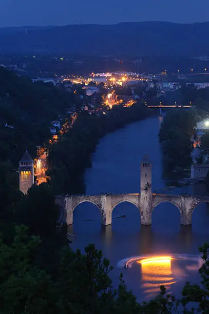 "The river Lot and the medieval Valentre bridge in Cahors, France.The light effect in front of the bridge is from a man doingt water-ski with a torch in his hand.Long exposure at 10PM."