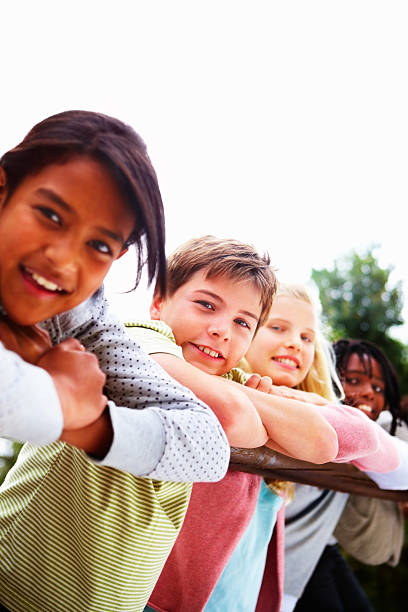 istock Happy boys and girls leaning on railing 176006687