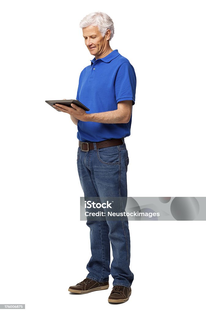 Senior Man Using Digital Tablet - Isolated Full length of senior man in casual wear surfing internet on digital tablet. Vertical shot. Isolated on white. Computer Stock Photo