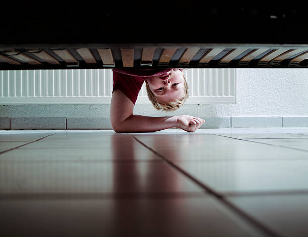 Looking Under Bed stock photo