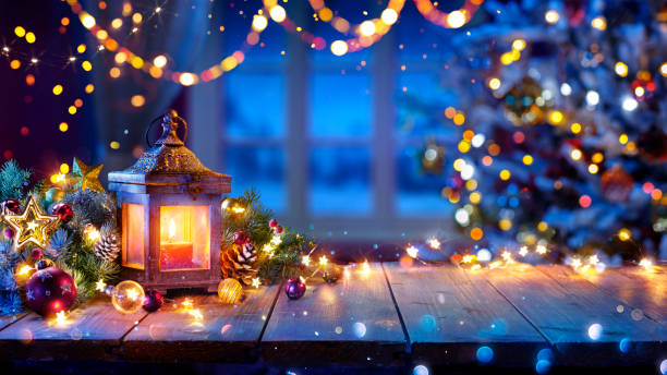 Lantern And Christmas Tree Glowing On Table In Blue Home Interior Merry Christmas - Advent At Home - Decorations And Bokeh images of decorated christmas trees stock pictures, royalty-free photos & images