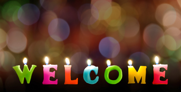 Colorful Welcome candles in text with rainbow bokeh blackground