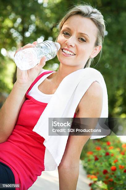 Young Athlete Taking A Break With Drink Of Water Stock Photo - Download Image Now - Active Lifestyle, Adult, Adults Only