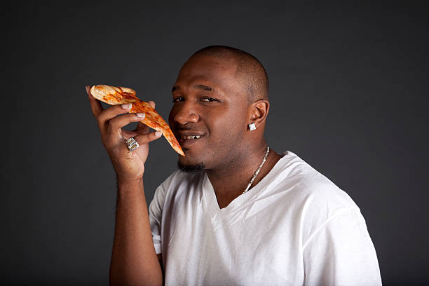 istock African American Man Holding Pizza Slice 176009547