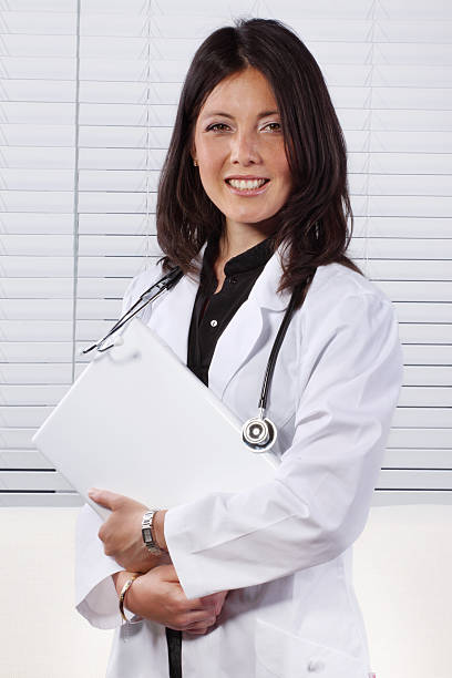 istock Smiling female doctor with stethoscope and documents 176010121