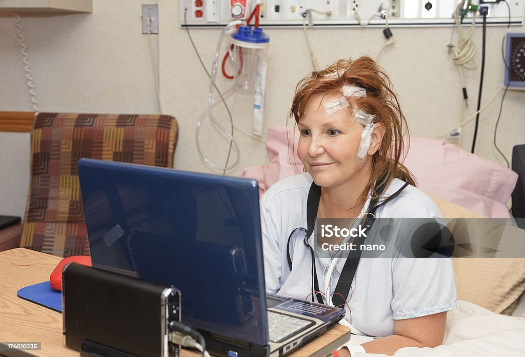 Femme dans un lit d'hôpital avec un ordinateur portable - Photo de Adulte libre de droits