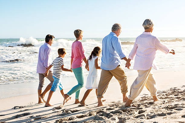 istock Three Generation Family Walking Holding Hands On Beach 176011208